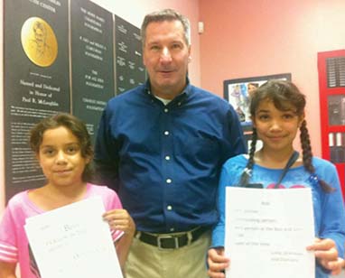Bob Scannell: The Dorchester Boys and Girls Clubs leader with two members, Precious Ruiz, left, and Damaris Nova. Photo by Bill Forry
