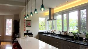 Their open kitchen's light fixtures include one found glass cover and several impeccable replicas.