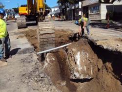 Lower Mills MWRA project: Workers unearthed a huge piece of ledge on Washington Street during the pipe replacement job last year. File photo