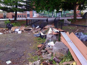 Lee School dumping: The scene last week after someone dumped trash outside the Lee School, which had just been cleaned by volunteers.