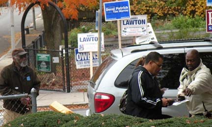 Election 2010: Cardinal Medeiros Manor in Ward 13: At right, a volunteer for write-in candidate Barry Lawton talked to a voter as Carlos Henriquez's father Julio looked on at left. 