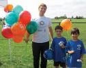Nick Montella, a student from Northeastern University, shared balloons with Dorchester Youth Soccer players Jaidyn and Jordyn Gross of Dorchester.