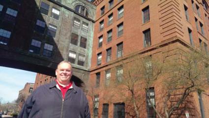 John Walsh : standing in front of his new Lower Mills digs.	Photo by Gintautas Dumcius