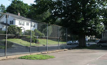 Savin Hill Tennis Court: The green at left along the fence is where the old oak tree once stood. Image courtesy Heidi Moesinger