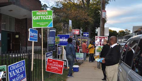 Chittick School on Mattapan-Hyde Park line: This voting station in Ward 18 can be a powerhouse double-precinct— and often is on a big election day. That wasn't the case on Tuesday, where even the evening rush was muted. Above, poll workers wait for some action outside of the precinct doors. 