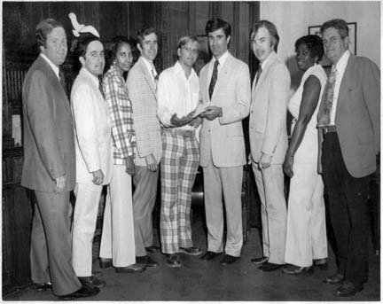 Codman Square Health Center Incorporated: April 1975 ceremony. Pictured, l-r, State Rep. W. Paul White, City Councillor Larry DiCara, Doris Brown, John MacNeil, Bill Walczak, Secretary of State Paul Guzzi, Craig Wall, Mona Scantlebury, and Charles Murphy.