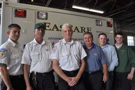 Eascare rescuers: Peter Todd, (center) an EMT dispatcher at Eascare Ambulance in Neponset is surrounded by some of the co-workers who saved his life in the moments following a severe heart attack last fall. Pictured left to right are George Stuart, Mark Donovan, Todd, CEO George Gilpin, Ryan Whitcomb and Dave Cavanagh.
