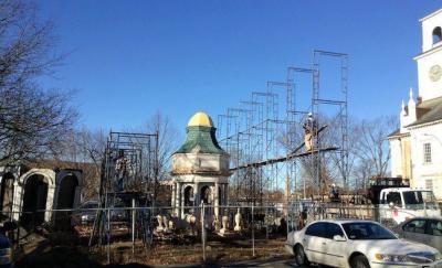 Progress at First Parish Church restoration project: Workers built a scaffold shelter around the steeple earlier this month. 