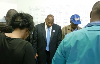 Russell Holmes: The candidate, center, prayed with supporters on election night.