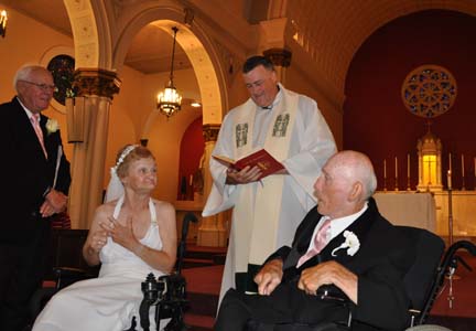 Happy couple: Rev. John Connolly, pastor at St. Brendan&amp;#039;s Church, celebrated a wedding Mass for Doris Bates and Jack Quinn last Saturday. At left is the bride&amp;#039;s brother Earl Bates. Photo by Dennis Walsh