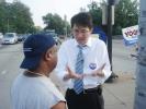 Mayoral candidate Sam Yoon discusses issues with a supporter.