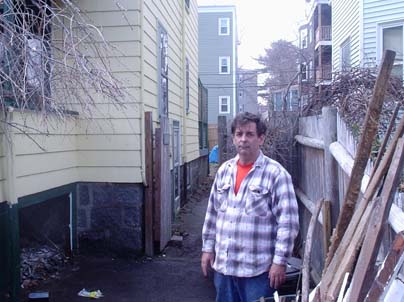 Dot Rats not welcome: Paul Shea with the remains of his porch, which he partly dismantled in an attempt to rid his property of rats. Photo by Alex Owens