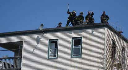 St. Margaret Street Fire: One firefighter was injured in the Saturday blaze. Above, firefighters work on the roof of 39 St. Margaret St. Photo by Adam Pieniazek