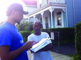 Hitting the streets: Cesar Monteiro, 19, spoke with a resident of North Avenue in Roxbury as he collected survey responses this week. 	Photo courtesy CVC UNIDO