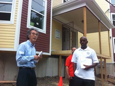 Woodcliff Street Homes: Michael Kozu, left, speaks as homebuilder Vargas DaSilveira and city ISD asst. commissioner Darryl Smith listen outside 6 Woodcliff Street.