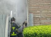 Firefighters enter house on River Street