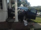 SUV on front porch of 44 Hill Top St.