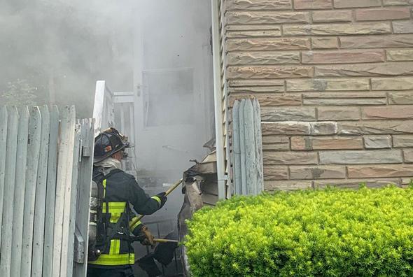 Firefighters enter house on River Street