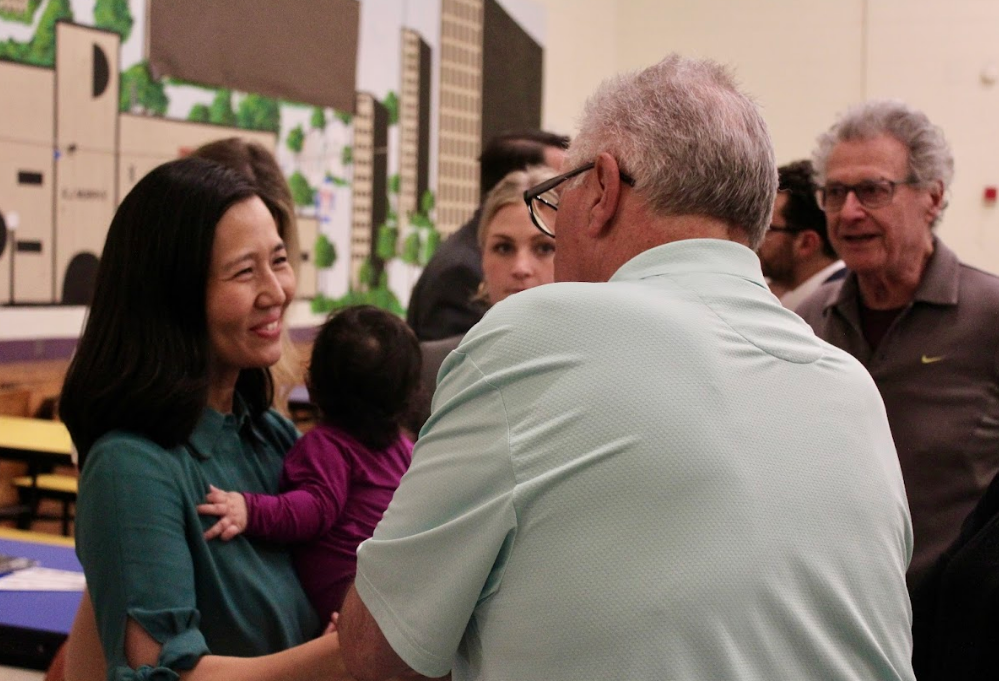 Mayor Wu and her daughter Mira greeted residents at last week's Pope's Hill Neighborhood Association meeting at the Murphy School. Cassidy McNeeley photo