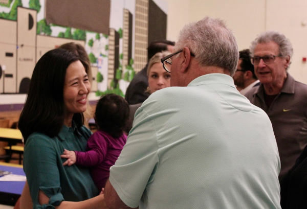 Mayor Wu and her daughter Mira greeted residents at last week's Pope's Hill Neighborhood Association meeting at the Murphy School. Cassidy McNeeley photo