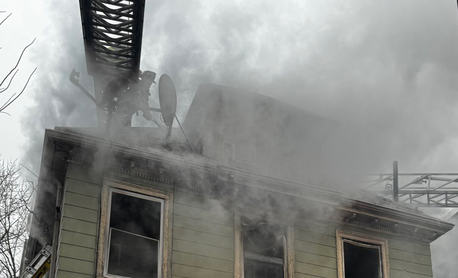 Firefighter in smoke on the roof, photo by BFD